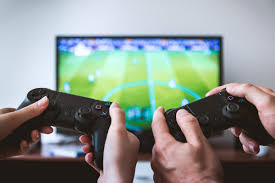 Two people playing on a tv